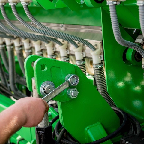 Mechanics repair a combine harvester