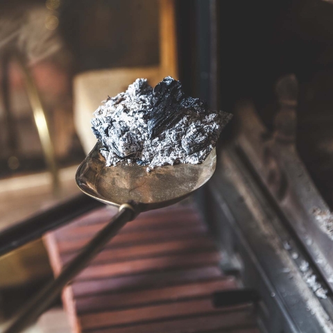 Cleaning ash out of a fireplace