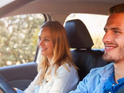 Happy couple driving in a car